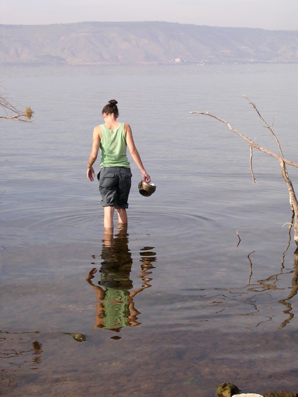 Collecting water for cooking in the Sea of Galilee, Israel