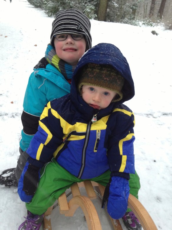 Amaya and her new friend Benjamin enjoying being pulled along on a sled - beats a pram any day!